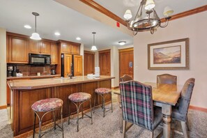 Enjoy cooking and dining in this well-appointed kitchen with a central island and dining table.