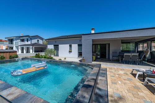 First floor villa with pool, surrounded by greenery