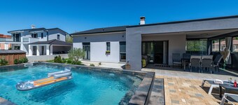 First floor villa with pool, surrounded by greenery