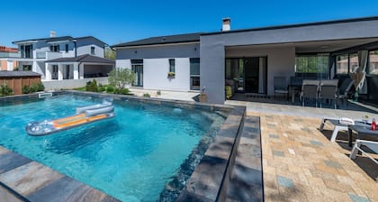 First floor villa with pool, surrounded by greenery