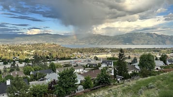 A residential area with houses, a gas station, and a mountain backdrop.