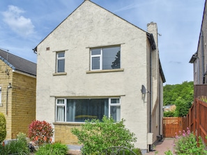 A two-story house with a large window and a satellite dish. - Huddersfield House, Wood View (Huddersfield)
