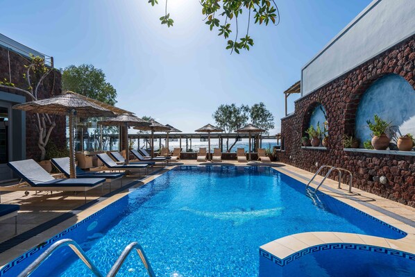 Seasonal outdoor pool, open 6:00 AM to 9:00 PM, pool umbrellas