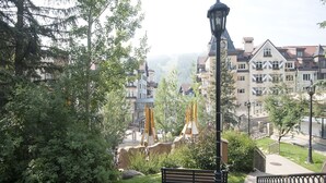A park with a lamp post, benches, and a playground. - Westwind 407 (Vail)