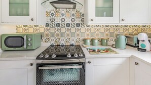 A kitchen with a stove, microwave, and cabinets.
