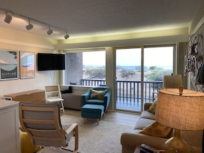 Enjoy a beach view from the large window, relax in the seating area with a TV and comfortable furniture.