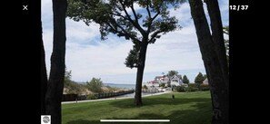 Surrounded by a serene landscape, this property offers a tranquil escape with a lawn and a body of water in view.