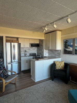 Enjoy cooking in this well-equipped kitchen with a central island, microwave, and stainless steel appliances.