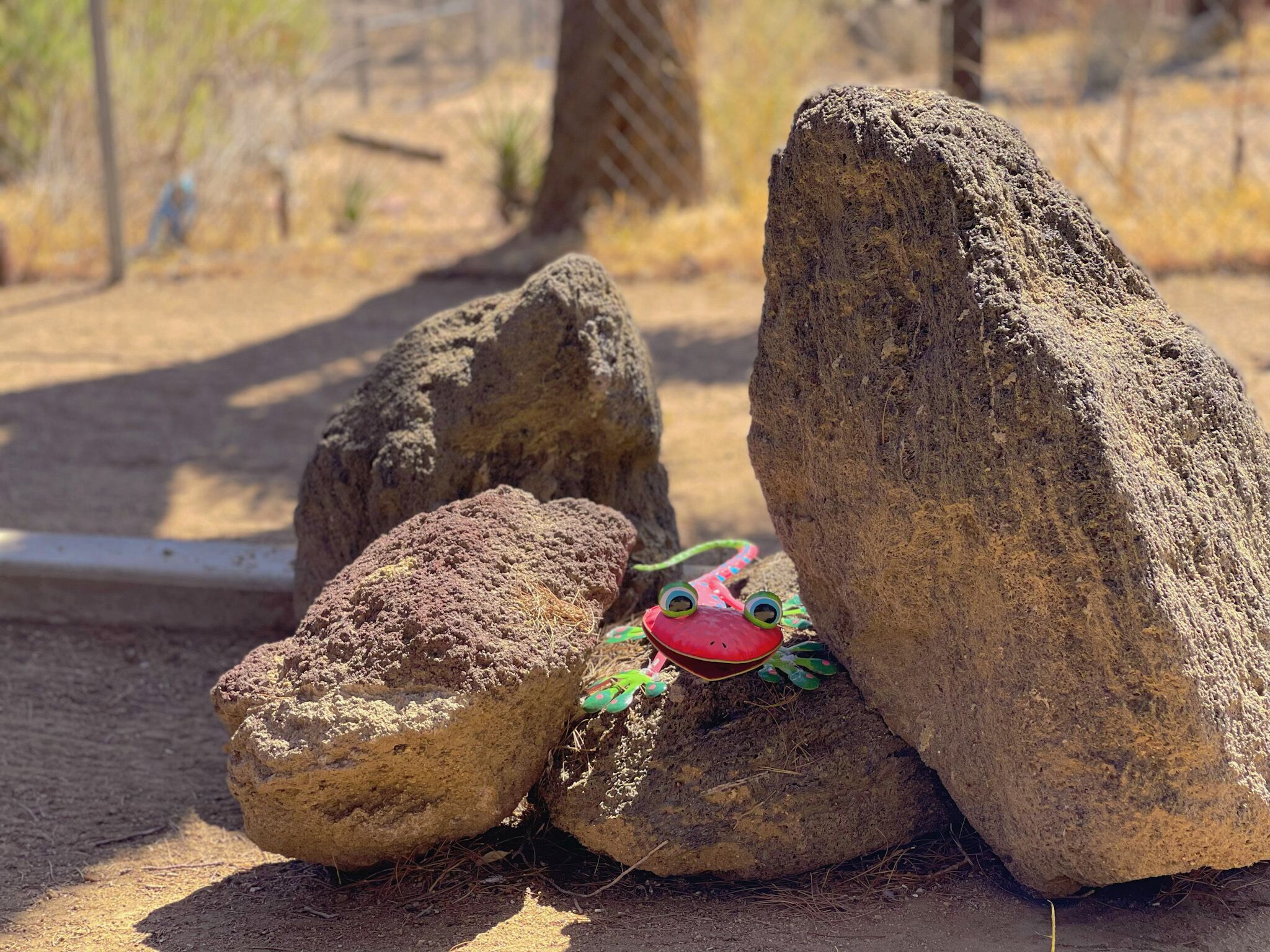 A rock formation with a small frog-like creature on one of the rocks.