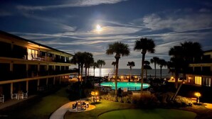 A resort with a pool, golf course, and ocean view at night. - Follow The Sun at Ocean House 211 (St. Augustine)