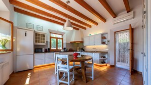 A kitchen with white cabinets, a wooden ceiling, and a tiled floor. - Sa Finqueta Luxury Elegant Mansion with breathtaking views in Sóller (Sóller)