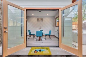 A modern interior with a dining area, a kitchen, and a visible outdoor space. - MaRVELOUS MiDCENTURY-Hot Tub, 5 Blocks to Downtown (Paso Robles)