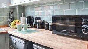 A kitchen with a microwave, coffee maker, and fruit bowl. - 1 bedroom accommodation in Bridlington (Bridlington)