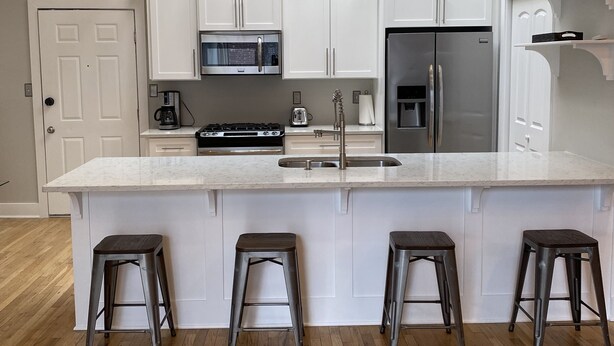 A modern kitchen with a large island, stainless steel appliances, and pendant lighting. - Beautiful and spacious loft in the Heart of Atlanta! (Atlanta)