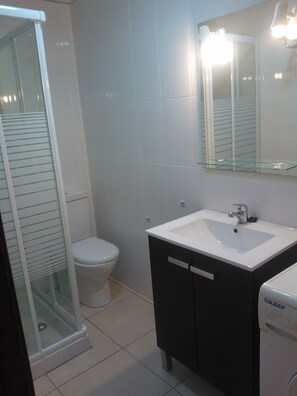 Shower, hair dryer, towels, toilet paper