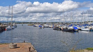 A marina with multiple sailboats docked, calm water, and a clear sky. - 2 bedroom accommodation in Newburgh, near Cupar (Newburgh, near Cupar)