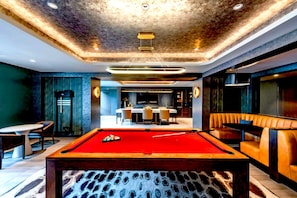 A billiards table in a modern room with a pool table, seating area, and a dining setup. - Prime Location Apt | Steps from Metro | Gym (Arlington)