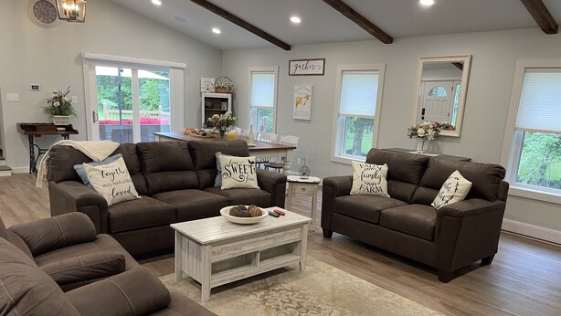 A spacious living room with two brown leather sofas, a white coffee table, and a patterned rug. - The Silliman House - New renovation, Farmhouse Chic, close to baseball parks (maryland)