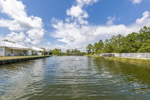 Enjoy a serene riverside retreat with a boat on the water and a restaurant or café nearby.