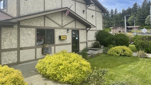 A building with a stone facade, a 'Lobby' sign, and a small American flag. - Baranof Lodge (Sitka)