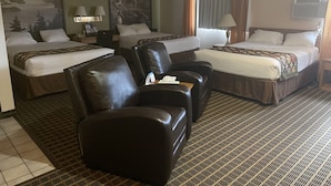 A hotel room with two beds, a sofa, and a desk. - Baranof Lodge (Sitka)