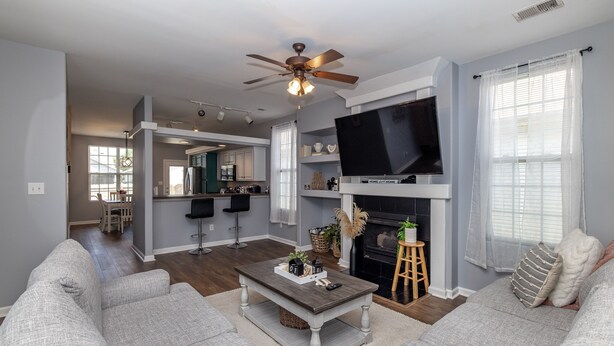 A living room with a gray sofa set, a coffee table, a TV mounted on the wall, and a fireplace. - ⭐️⭐️⭐️⭐️⭐️ Home next to KHP/Downtown (Lexington)