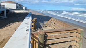 A wooden boardwalk leading to a beach with a clear sky. - Beautiful direct ocean front beach access condo (Satellite Beach)