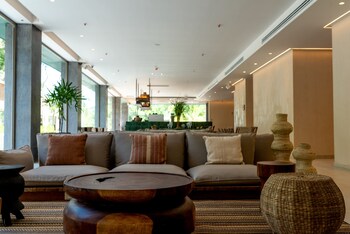 Sitting area in hotel lobby at Motto by Hilton Tulum