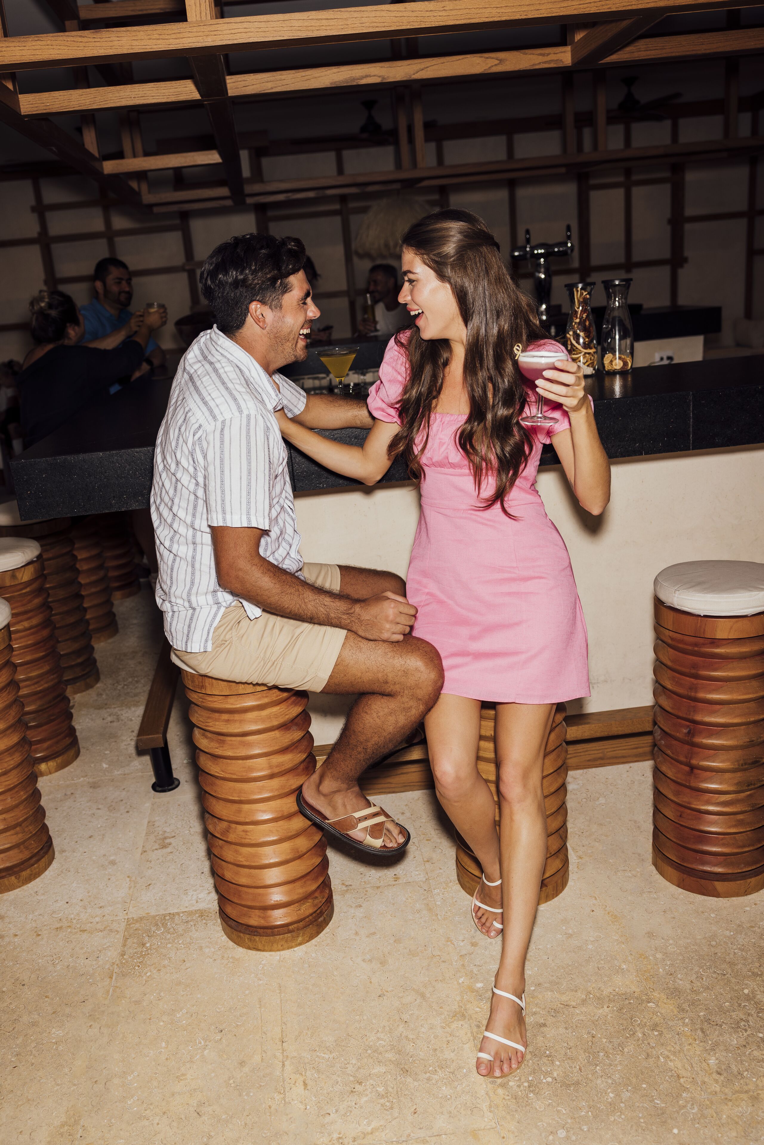 A bar area with wooden stools and a counter.