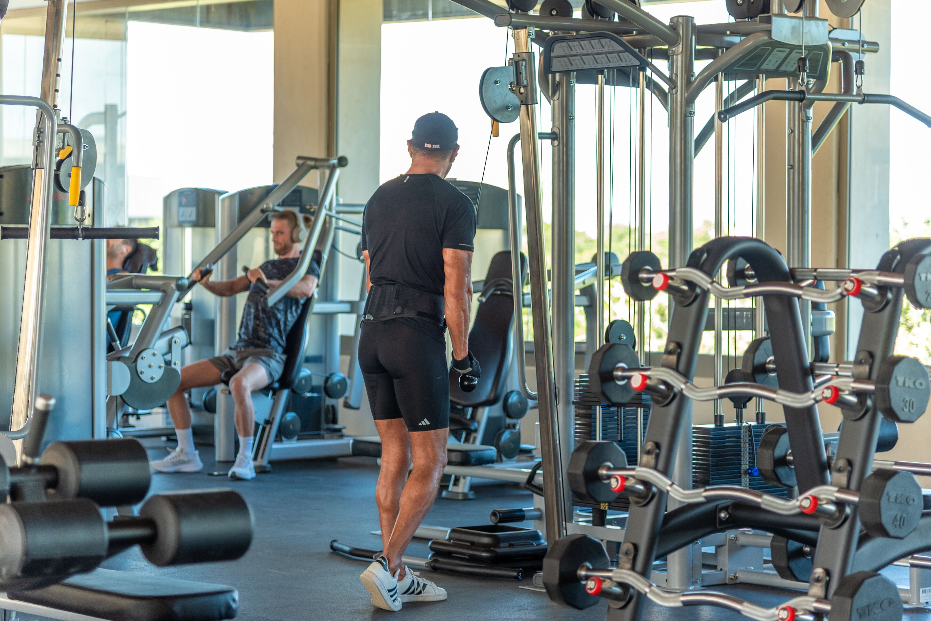 A gym with various exercise equipment, including dumbbells and weight machines.