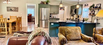 Riverfront Gem with Big Deck, Fishing & Adventure. Comfy beds, upgraded beauty