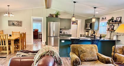 Riverfront Gem with Big Deck, Fishing & Adventure. Comfy beds, upgraded beauty
