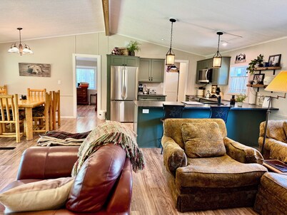 Riverfront Gem with Big Deck, Fishing & Adventure. Comfy beds, upgraded beauty