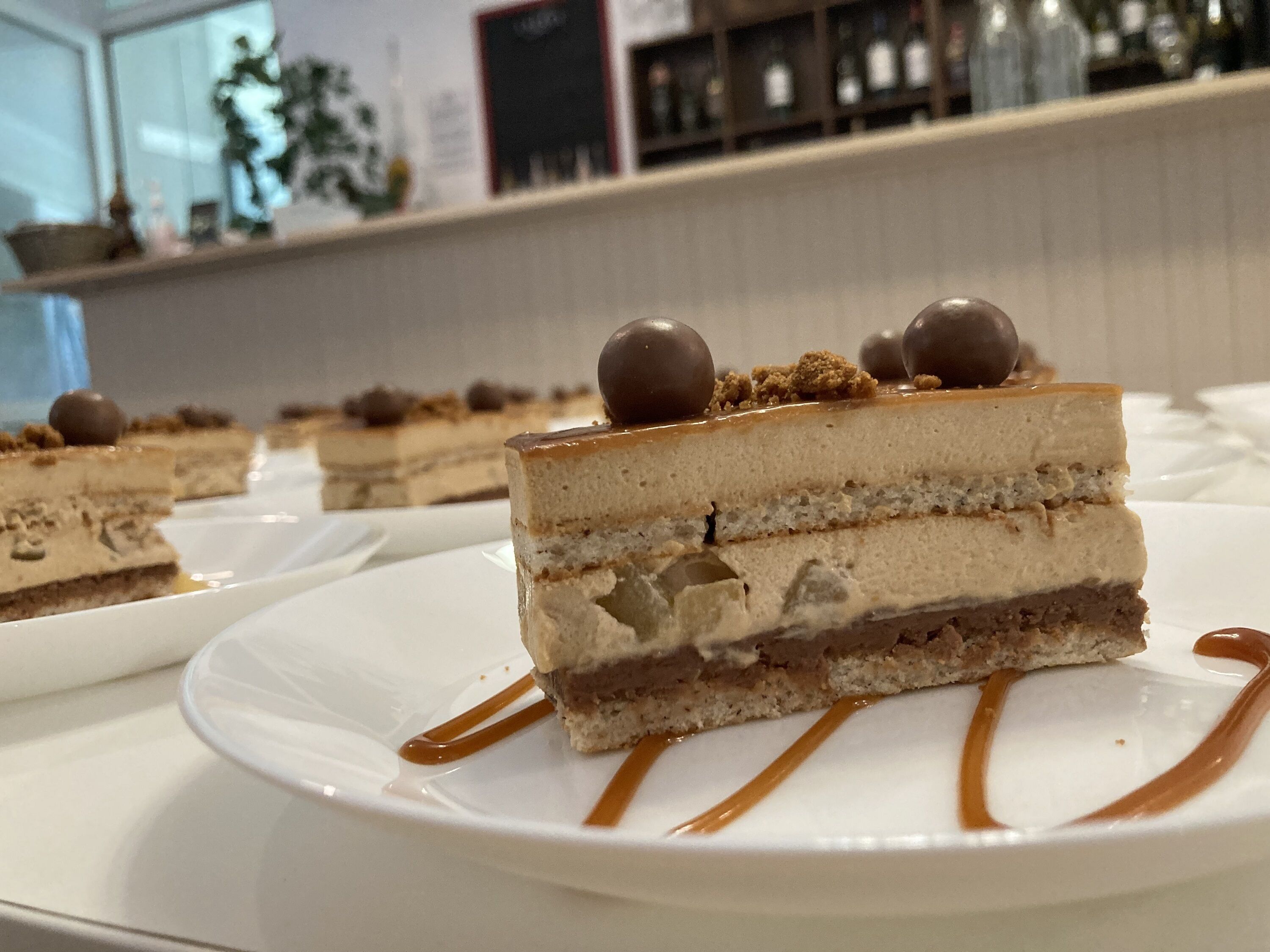 A dessert with caramel drizzle on a white plate.