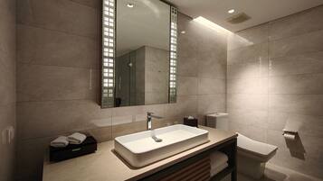 A modern bathroom with a large mirror, a rectangular sink, a toilet, and a towel rack.