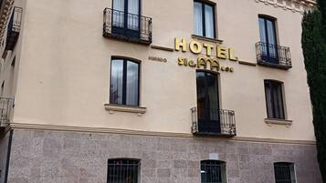 Un edificio di un hotel con uno stile architettonico classico, caratterizzato da una segnaletica ben visibile con la scritta