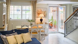 A living room with a sofa, a table, and a lamp. - Holiday Home La Reserva de Alvarito with Pool, Garden, Terrace & Wi-Fi (Marbella)