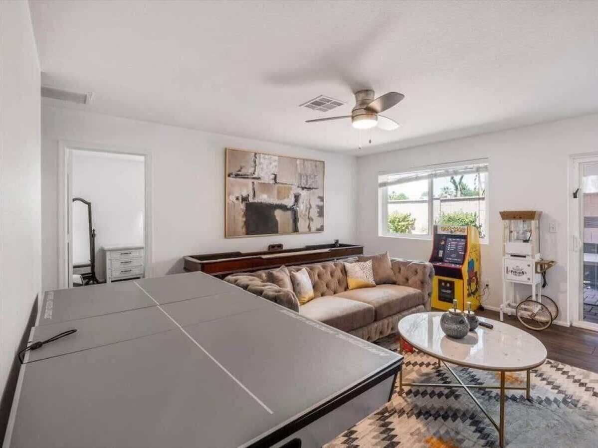 Relax in your bright, stylish living room with a plush sofa, fun arcade games, and everything you need to feel right at home.
