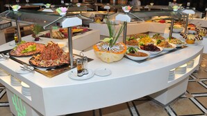 A buffet with various dishes and a glass display case. - Hotel Kanta Resort & Spa (Port El Kantaoui)