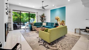A modern living room with a sectional sofa, a coffee table, and a large window.