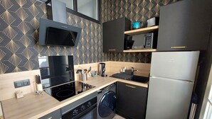 A modern kitchen with a built-in oven, microwave, and dishwasher.
