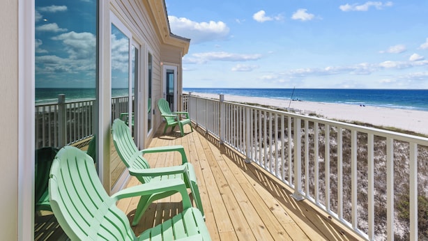 A wooden deck with green chairs overlooking a beach. - Gulf Front Beach House | Pet Friendly | Panoramic Coastal Views (Gulf Shores)