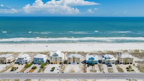 A beachfront hotel with multiple buildings, a sandy beach, and the ocean in the background. - Gulf Front Beach House | Pet Friendly | Panoramic Coastal Views (Gulf Shores)