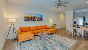 A modern living room with a sectional sofa, a dining area with a table and chairs, and a kitchen in the background. - Welcome to #BestStayEver Nashville/Old Hickory TN (Nashville)