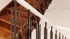 A grand staircase with ornate wooden balusters and a white handrail. - Agora Athens Suites (Athens)