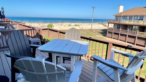A deck with a table and chairs overlooking a beach. - Fantastic Ocean Views, Community Pool, Dogs Welcome, Open Deck, KHSDA5 (Kitty Hawk)