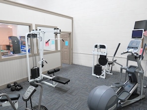 A gym with exercise equipment including a bench press, weight machines, and a treadmill. - Fantastic Ocean Views, Community Pool, Dogs Welcome, Open Deck, KHSDA5 (Kitty Hawk)
