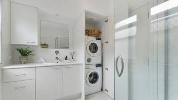 Bathtub, hair dryer, towels, shampoo
