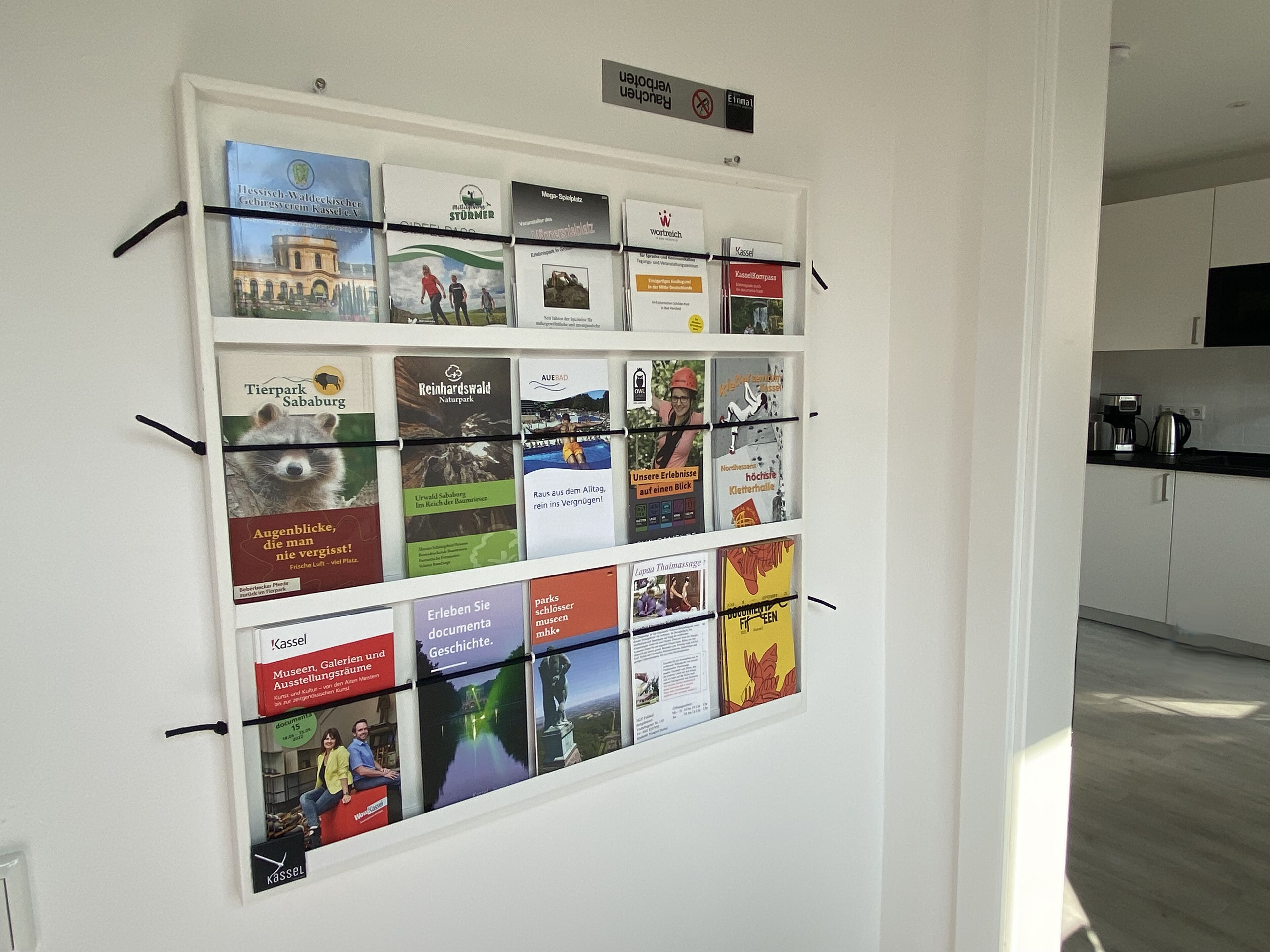 A wall with framed informational posters about local attractions and parks.