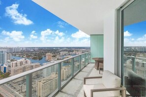 A balcony with a view of a cityscape, including buildings and a body of water. - Amazing Views at a Complete Resort BY rent4us (Hollywood)